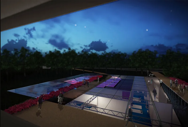 Aerial view of the illuminated skylights and planted beds at twilight beneath a darkening sky