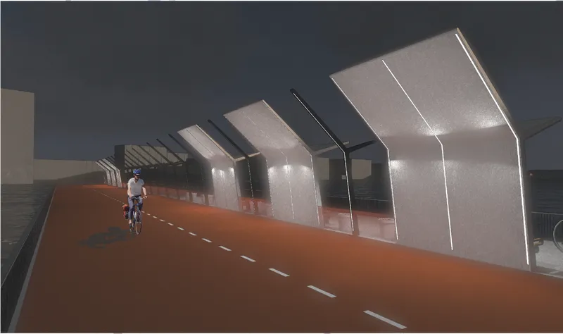 Night view of the illuminated metal canopies along the orange bike lane with a lone cyclist