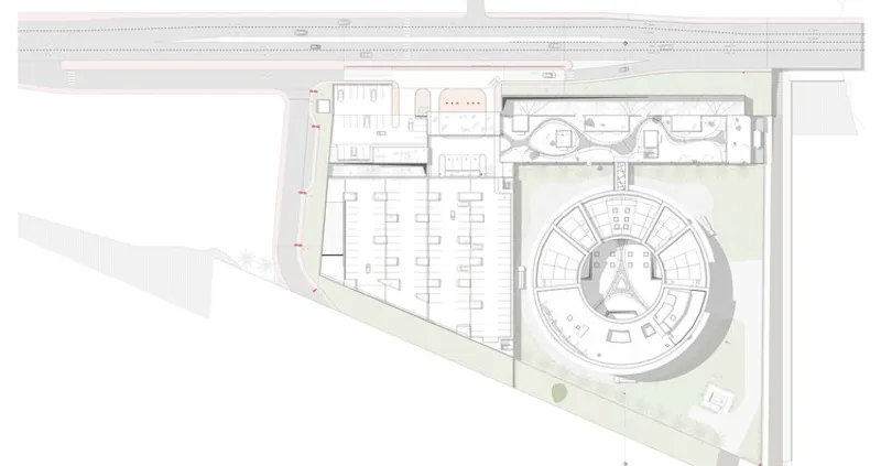 Floor plan drawing showing a circular auditorium, rectangular galleries, and landscaped courtyard areas