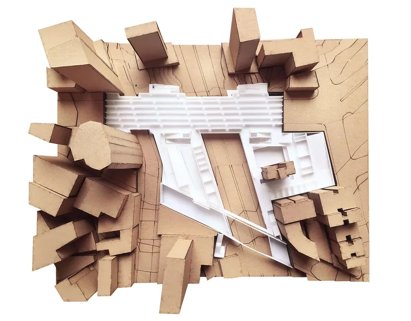 Physical model in top view showing the triangular building form amid surrounding urban fabric