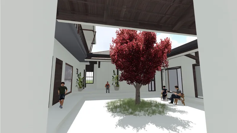 Interior courtyard with white paved surfaces centered on a red-leafed tree and figures seated on benches