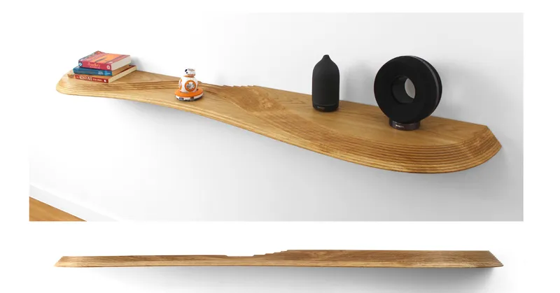Laminated timber floating shelf holding books and decorative objects with profile view below showing tapered edge