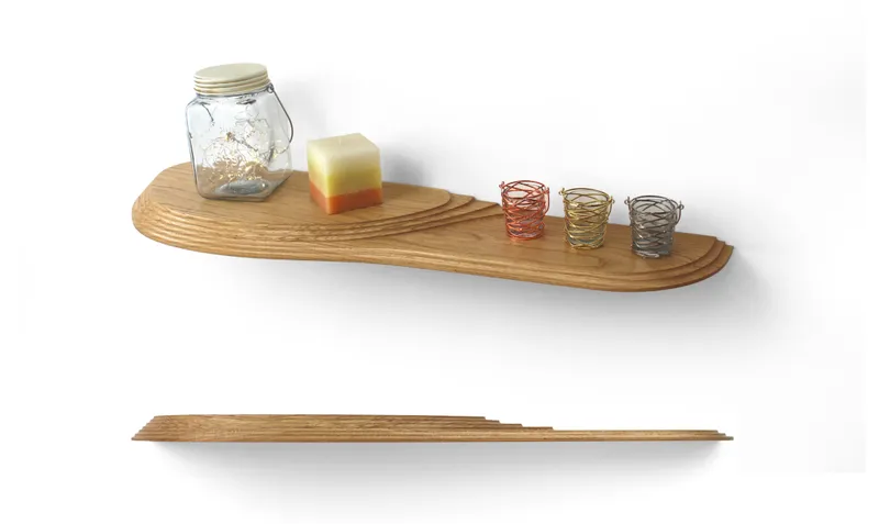 Wall-mounted shelf in layered wood displaying a glass jar, soap bar, and wire tea light holders