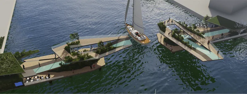 Aerial view of floating platforms with planted beds and a sailboat moored alongside the water