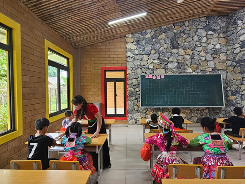 Classroom interior with timber slat ceiling, stone feature wall, and students seated at desks