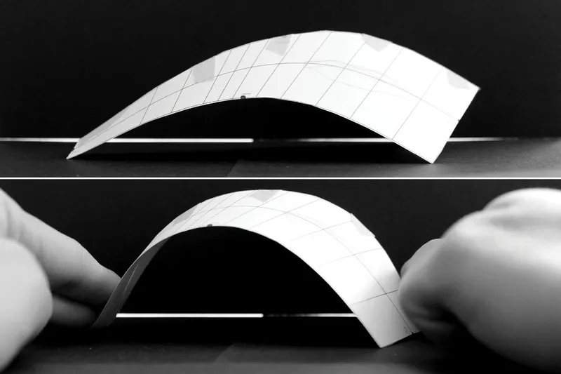 Physical model of gridded curved shell forms arching over a flat base