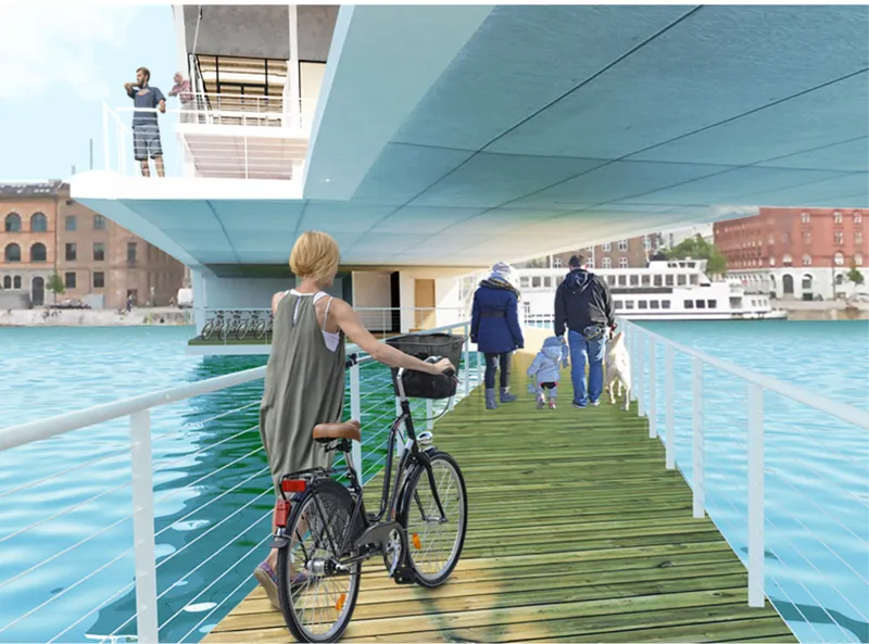 Timber boardwalk beneath the cantilevered volume with a cyclist and pedestrians crossing the water channel