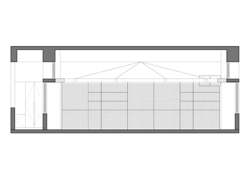 Section drawing revealing the cable-supported roof structure above a perforated panel wall and stairwell