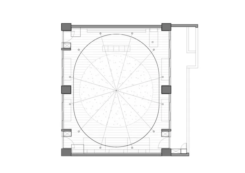 Floor plan drawing showing a circular central space with radiating segments surrounded by perimeter service zones
