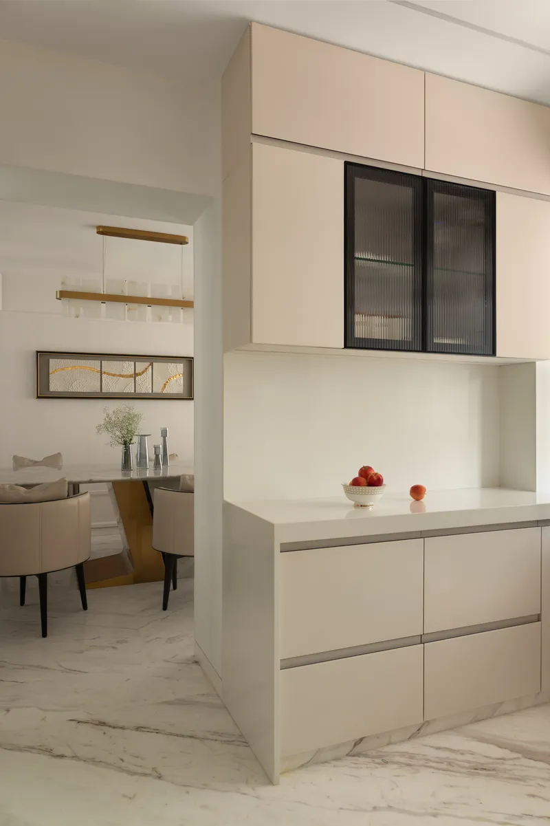 The pantry, with handleless cream cabinetry and a fluted glass overhead display unit.