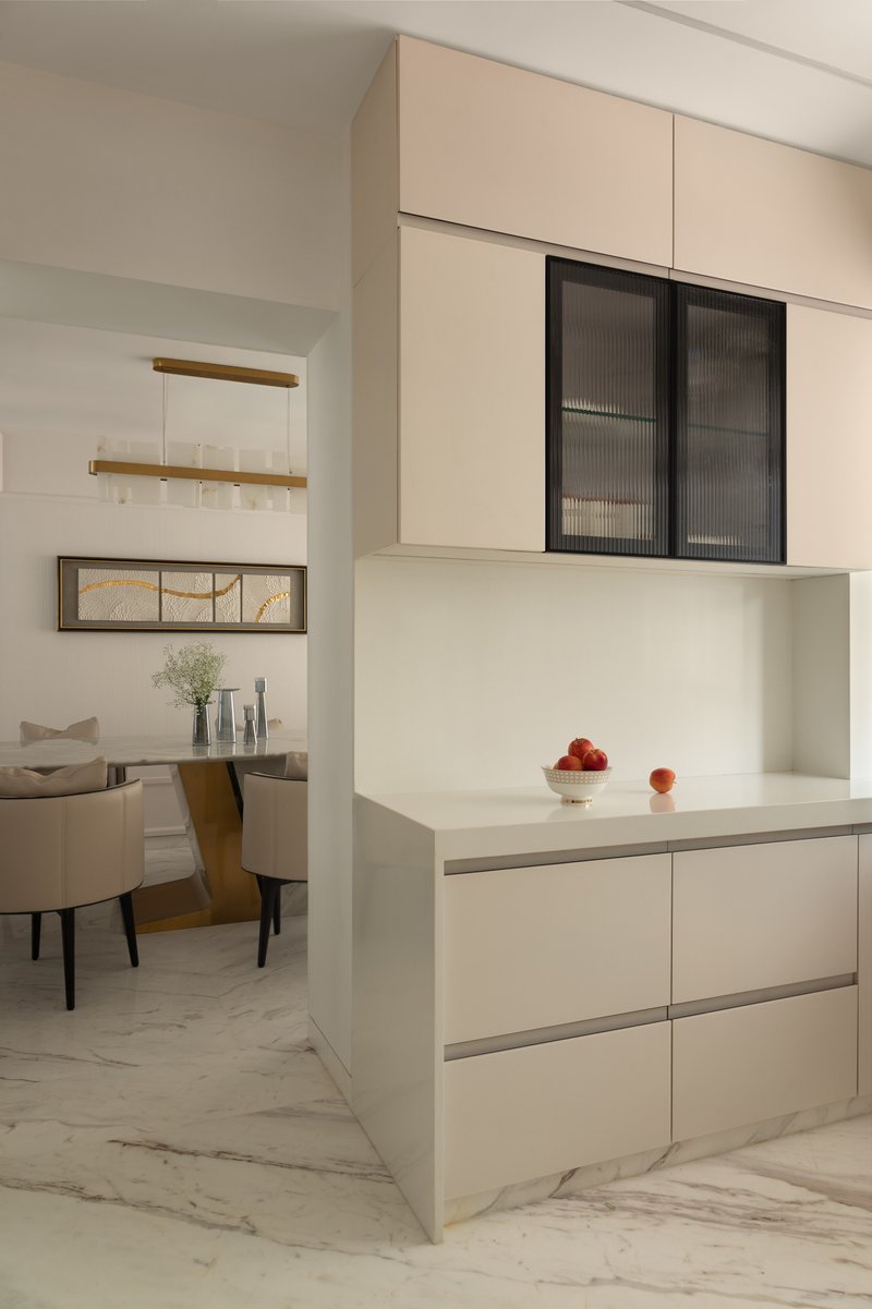 The pantry, with handleless cream cabinetry and a fluted glass overhead display unit.