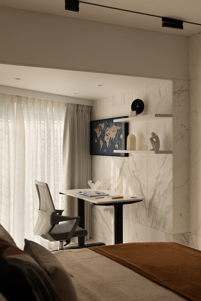 A study corner with a sit-stand desk and a marble feature wall.