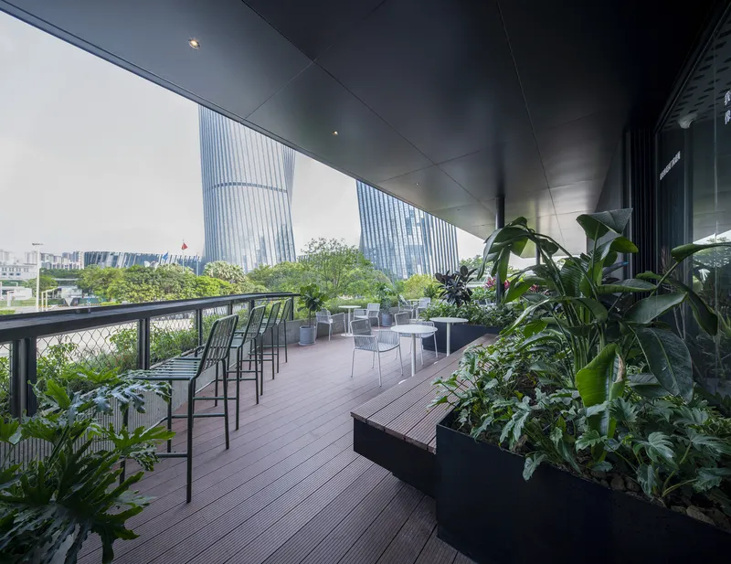 Covered terrace with composite decking, metal railings and planting boxes under a paneled soffit