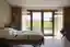 This image showcases a bright and airy hospital room designed for patient comfort and healing. The r