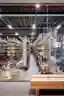 This architectural image showcases the interior of a large warehouse, characterized by its high ceil