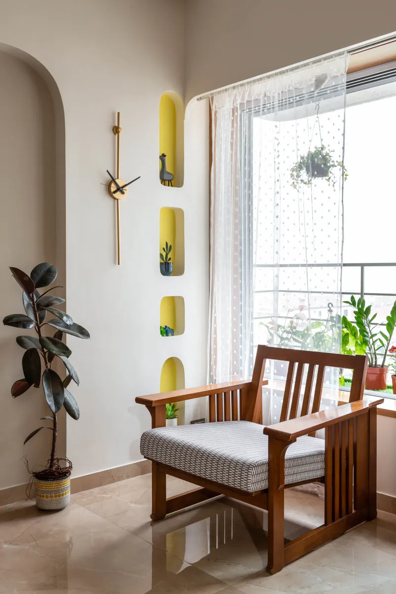 A limited living room space urged an exploration of wall niches, tactical furniture distribution, and maximising the utility of elements with the help of design.  Anuja Kambli