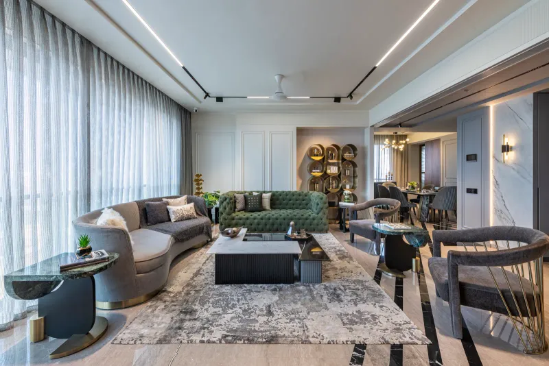 The living room is underpinned by grey marble flooring with black marble inlay. The palette, a soothing grey, is inspired by the beach at twilight. Prashant Bhat 