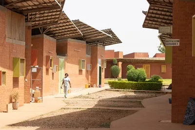 This architectural photograph showcases a hospital building with a brick facade and a series of inte