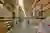 This image showcases the interior of a large warehouse, characterized by its high ceilings and rows 