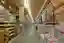 This image showcases the interior of a large warehouse, characterized by its high ceilings and rows 