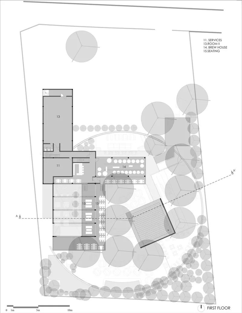 First floor plan showing rectangular volumes arranged around a curved landscaped courtyard with tree canopies