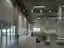 This architectural image showcases the interior of a large industrial warehouse or factory. The spac