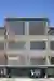 This architectural image showcases the facade of an industrial building, characterized by its corrug