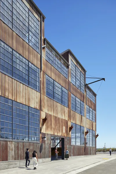 This architectural photograph showcases an industrial building with a striking facade of corrugated 