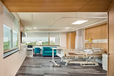 This image showcases a modern hospital room designed for patient comfort and functionality. The room