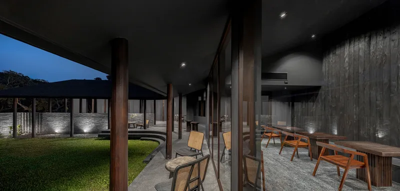 Glazed dining pavilion looking across the courtyard to the sheltered walkway opposite