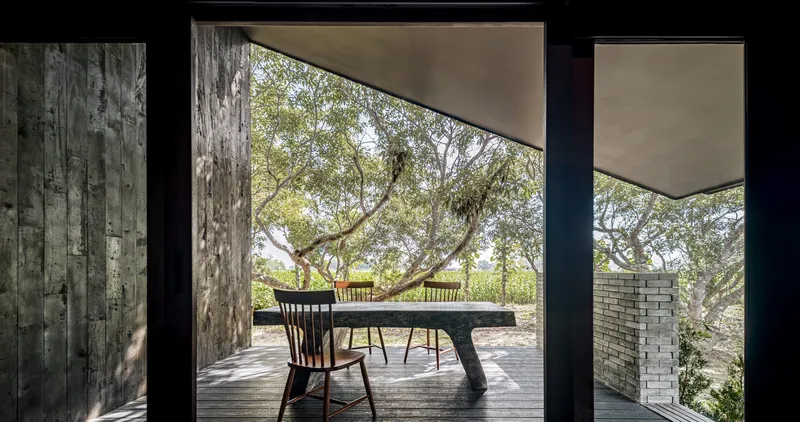 Private dining alcove framed by a large opening onto the orchard